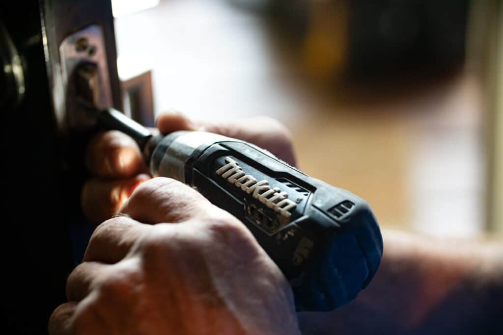 A tradesperson working on a kitchen or bathroom fitting project